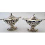 A pair of pedestal hinged salts with pierced decoration & blue liners, Birmingham 1910. Condition