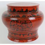 A large Indo Persian red lacquered covered pot of baluster form with black hand decoration.