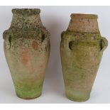 A pair of small antique hand thrown amphoras well weathered. Tallest 43cm. (2). Condition report: