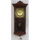 A contemporary Metamec striking & chiming wall clock in mahogany style case. Pendulum & key present.