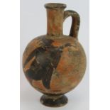 An ancient Greek style black figure wine flask featuring a couple dancing, probably 19th century