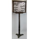 An early 20th century floorstanding classroom abacus on cast iron stand marked Educational Supply