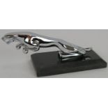 A vintage chrome Jaguar car mascot mounted on a black marble plinth. Mascot length 19cm. Condition