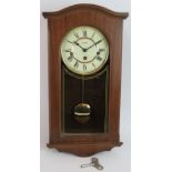 An Acctim Westminster chiming wall clock in mahogany case. Key & pendulum present. Height 47cm.