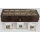 A mother of pearl inlaid rosewood cribbage box with contents including pegs, playing cards & dice