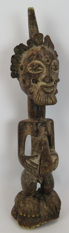 A 19th Century carved African Songye power figure, Democratic Republic of Congo. Carved wood with