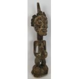 A 19th Century carved African Songye power figure, Democratic Republic of Congo. Carved wood with