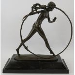 A bronze figure of a nude girl with hoop mounted on a black marble plinth, unsigned. Height 43cm.