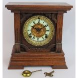 A late 19th century striking mantel clock by Ansonia Clock Co, 8 day summit movement, oak case.