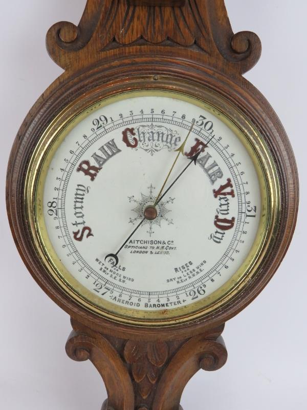 An Edwardian carved oak cased wheel barometer by Aitcheson & Co, London and Leeds. Height 90cm. - Image 2 of 3