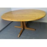 An Ercol ash blonde Southwold oval dining table, on a quatreform pedestal base. Condition report: No