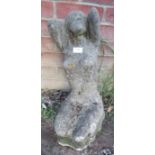 A nicely weathered reconstituted stone garden ornament in the form of a nude posing. Condition