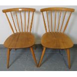 A pair of mid-century Ercol blond bow top occasional chairs, model 449. With removable seat cushions