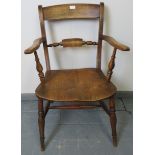 A turn of the century elm and beech open sided armchair, on turned supports with stretchers.