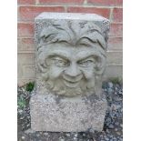A nicely weathered reconstituted stone garden pedestal with green man mask decoration. Condition