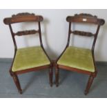 A pair of William IV rosewood occasional chairs with green velvet drop-in seat pads and featuring