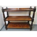 A Victorian mahogany three tier buffet, with fluted uprights, on tapering bun feet. Condition