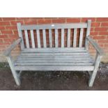 A nicely weathered slatted teak two-seater garden bench. Condition report: No issues. H87cm W120cm