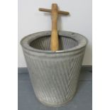 A vintage galvanized wash tub with original pine paddle. Condition report: Paddle is missing spokes.
