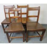 A set of four Georgian country made oak kitchen chairs, on square supports with stretchers.