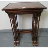 A quartetto of Edwardian Regency revival mahogany nesting tables, featuring flame mahogany inlay and