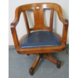 A vintage medium oak swivel desk chair, with seat upholstered in blue leatherette. Condition report: