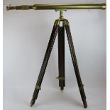 A contemporary brass telescope on adjustable wooden tripod. Telescope length 104cm. Condition