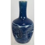 A Christopher Dresser for Linthorpe Pottery dimple bottle vase in blue glaze with white streaked