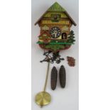 A mid century German cuckoo clock with moving figures. Needs restoration. Condition report: