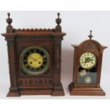 Two Edwardian mantle clocks, one in a Gothic oak case, the other with enamelled dial. Tallest