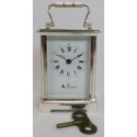 A silver plated Aquascutum of London 8 day carriage clock with enamel dial. Height 15cm. Condition