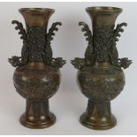 A matched pair of Japanese bronze vases with rooster decoration, early 20th century. Height 32cm (
