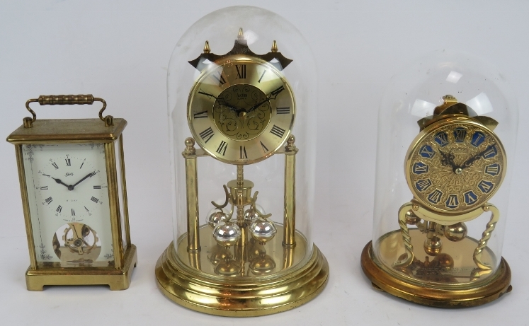 A German Kundo 400 day anniversary clock under a glass dome, a similar Acctim clock and a Schatz 8