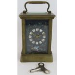 A fine quality brass cased carriage clock with ornately decorated black enamel dial. Key present.