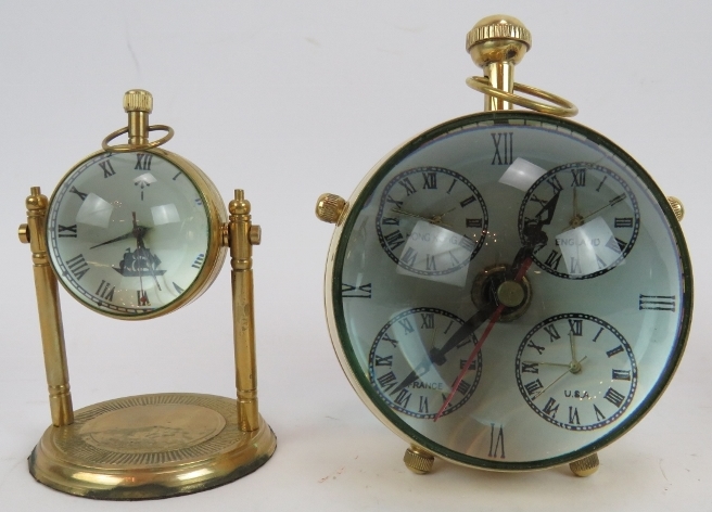 A brass cased orb quartz clock, a similar clock on stand and a German Europa alarm clock in a - Image 2 of 6