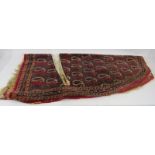 An early 20th century Persian saddle blanket with repeat Paisley pattern. 110cm x 107cm. Condition