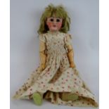 An early 20th century porcelain Bisque headed doll with jointed limbs. Head marked S.A. 1049/11