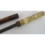 A 19th century Rattan sword stick with carved bone handle depicting a dog in hunting attire under