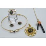 A 9ct yellow gold & sapphire pendant, the nine sapphires forming a centre cluster, a 9ct yellow gold