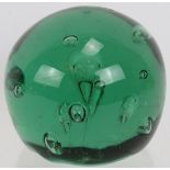 An antique green glass end of day dump weight with pontil scar to base. Diameter 11cm. Condition