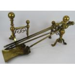 A three piece antique brass fire iron set and a pair of similar brass andirons (5). Condition