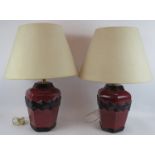 A pair of Retro porcelain based lamps black over burgundy design with cream shades. Lamp height