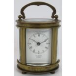 A small elliptical shaped 8 day carriage clock in glazed brass case. No key. Height 11cm.