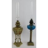 Two antique French oil lamps, one of gilt brass Empire Revival form with ram's head masks, the other