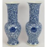 A pair of antique Chinese porcelain vases hand decorated with blue floral motifs. Four character