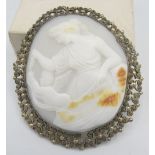 A large vintage cameo brooch in a filigree frame depicting a classical maiden tempting a cherub with
