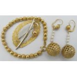 An 18ct yellow gold ball design bracelet, a pair of yellow metal & pearl drop earrings with