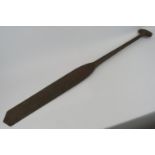 A carved hardwood paddle, possibly Polynesian. Length 110cm. Condition report: Age related wear.
