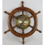 A Plastimo ships clock inset into a hardwood ship's wheel. Overall diameter 62cm. Condition