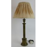 A patinated brass column table lamp with pleated silk shade. Overall height 70cm. Lamp height